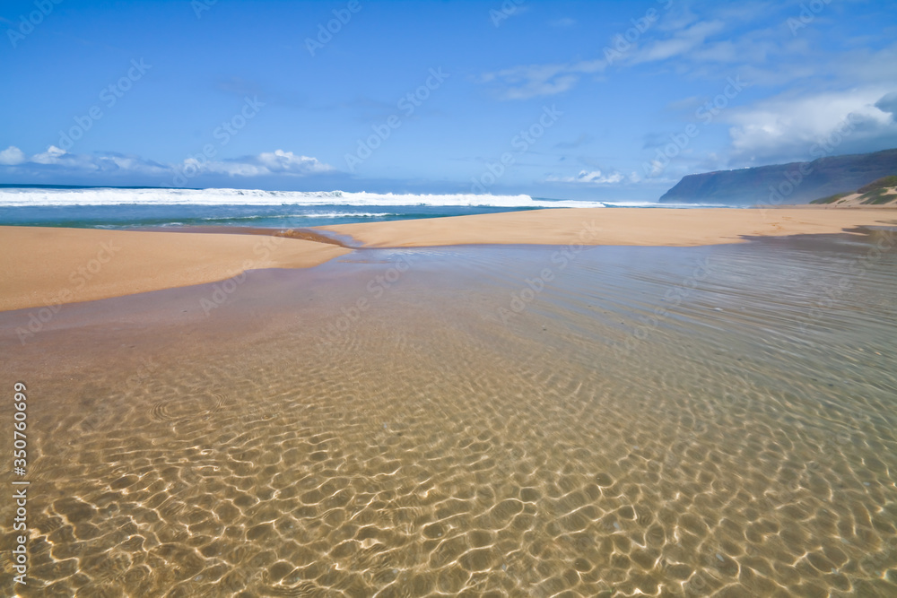 Fototapeta premium Queen's Pond Draining Into The Pacific Ocean With The Na Pali Cliffs in The Distance, Polihale Beach, Polihale Beach State Park, Kauai, Hawaii, USA