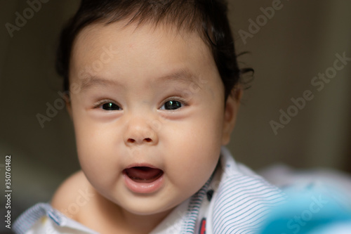 Happy baby boy playing on bed