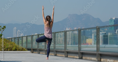 Woman do yoga at outdoor city