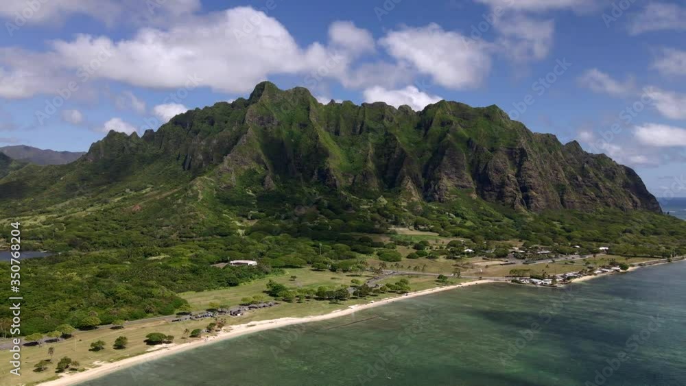 Wide drone shot of the Kualoa mountain range located on Oahu, Hawaii. Wide drone shot of the Kualoa mountain range located on Oahu, Hawaii.