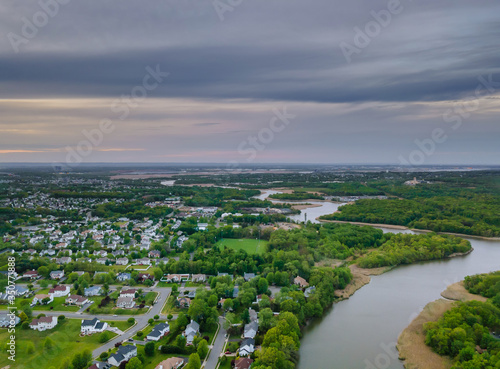 Aerial view waterfront suburban street of middle class suburban neighborhood with houses