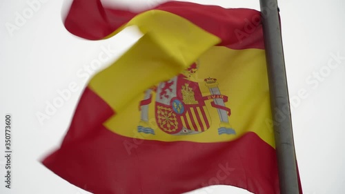 4K SHOT OF SPANISH FLAG WAVING IN THE WIND photo