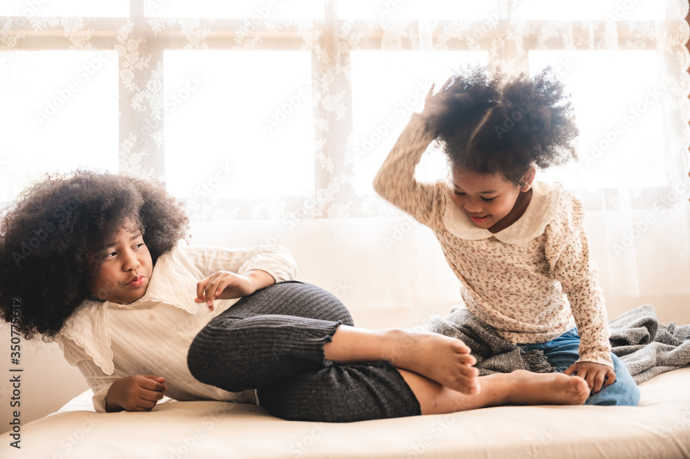 African American children relax playing on the bed at home African American children relax playing on the bed at home