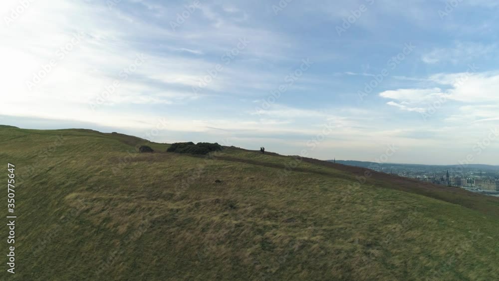 Two walkers on Salisbury Crags revealing Edinburgh Two walkers on Salisbury Crags revealing Edinburgh