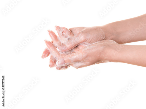 Female fingers in soap foam, close up. Caucasian woman thoroughly washing her hands, isolated on white.