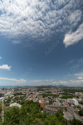 panoramic scene at Khao Rung Phuket viewpoint hilltop, home , building and green tree. Sea and mountain long distance, beautiful cloudy blue sky background at day time, nature and travel concept..
