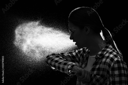 Coughing young woman on dar...