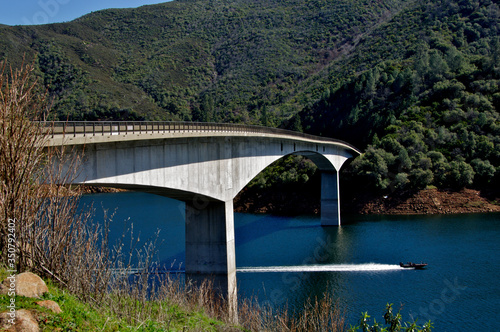 The Parrotts Ferry Bridge is a Prestressed concrete beam bridge with submerged piers. The slight sag in the middle occurred post construction but has been deemed safe, Calaveras County, California