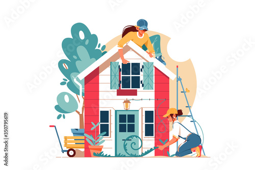 Two young attractive woman using equipment building house.