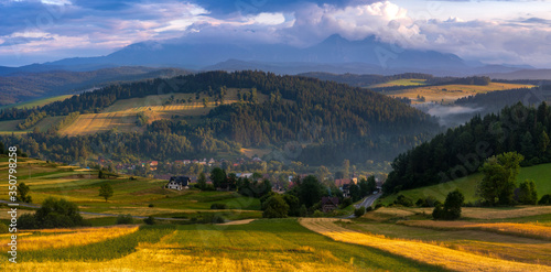 Beautiful landscape of Polish Spisz, undulating, fields on undulating hills, view of the Tatra Mountains
