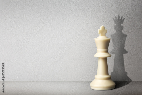 Chessman with shadow.The battle of competition and strategy ideas with market mechanism.Creative success business concept.