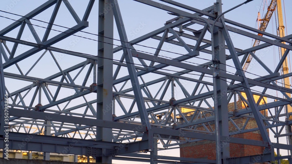 Construction of a building from metal structures. Preparation of the roof. Welding work. Joining steel beams. Construction of a building from metal structures. Preparation of the roof. Welding work. Joining steel beams.