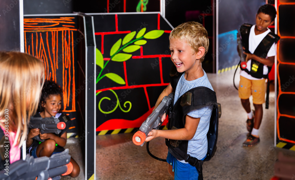 Preteen boy with laser pistol playing on labyrinth Stock Photo | Adobe ...