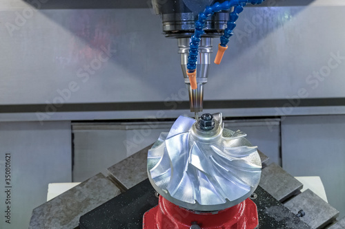 Five axis CNC machining center cutting jet engine turbine.