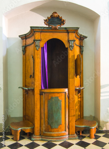 church interior, confessional, ready to absolve you from your sins photo