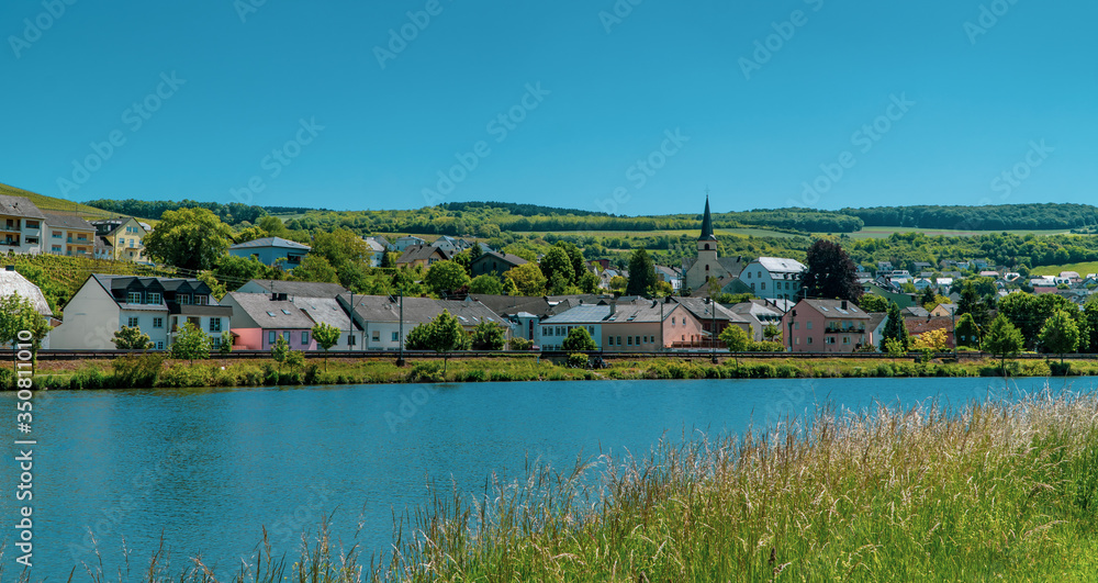 Beautiful German town with church tower on the Moselle river - Nittel, Germany