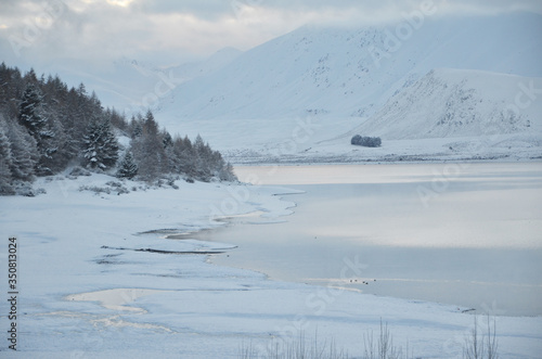 Beautiful snow scene of Lake tekapo, New Zealand. Picturesque by day and dazzling by night, Lake Tekapo is part of a UNESCO Dark Sky Reserve, making it the perfect spot for stargazing.