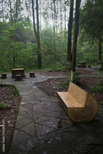 Wooden bench and table in Research Base of Giant Panda Breeding, Chengdu, China on a hot, summer day