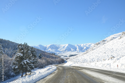 The winter snowy road from Lake Tekapo to Christchurch. The journey pass through several towns and along farmland, then the scenery will start to become mountainous. photo