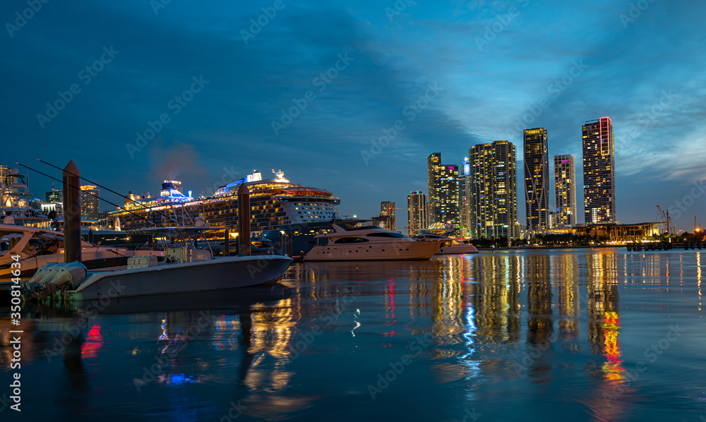 Cruise ship and Downtown skyscrapers in Miami. Miami Florida, skyline of downtown night colorful skyscraper buildings. Downtown Miami, Florida, USA.