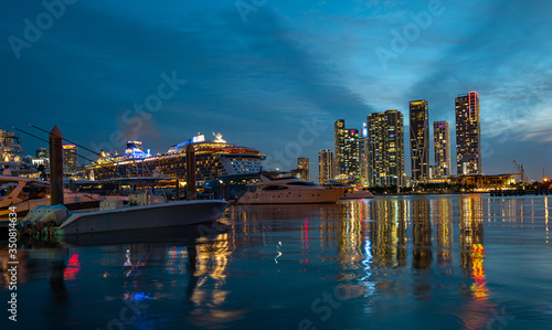 Cruise ship and Downtown skyscrapers in Miami. Miami Florida, skyline of downtown night colorful skyscraper buildings. Downtown Miami, Florida, USA.