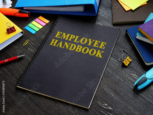 Employee handbook and papers with rules and procedures. photo