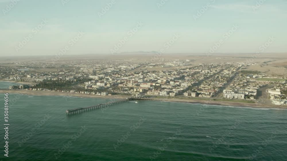 Aerial view of cityscape and sea against sky, coastline by city seen from airplane during sunny day - Sossusvlei, Namibia Aerial view of cityscape and sea against sky, coastline by city seen from airplane during sunny day - Sossusvlei, Namibia