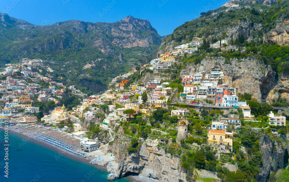 Beautiful Positano with comfortable beaches and clear blue sea on Amalfi Coast in Campania, Italy. Amalfi coast is popular travel and holyday destination in Europe. Aerial view.