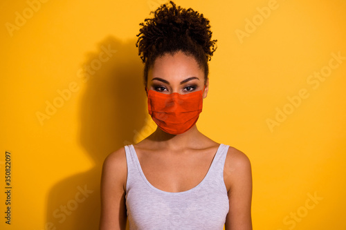 Close up photo beautiful amazing funny she her dark skin lady protect from covid-19 infection stay home look wear breathing mask casual tank-top isolated vivid yellow background