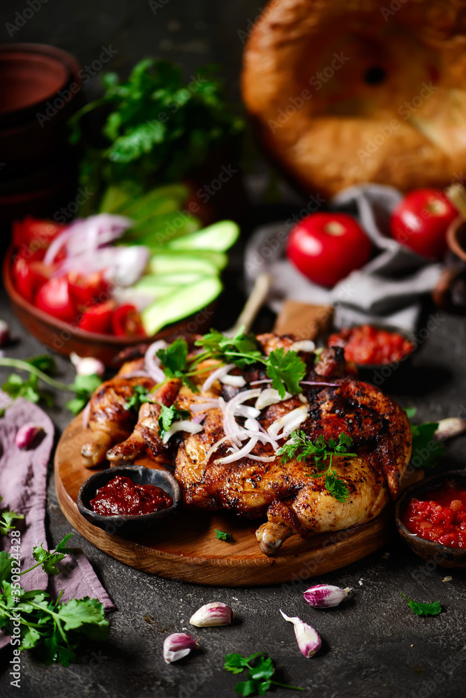 Chicken Tabaka.traditional Georgian dish .selective focus Chicken Tabaka.traditional Georgian dish .selective focus
