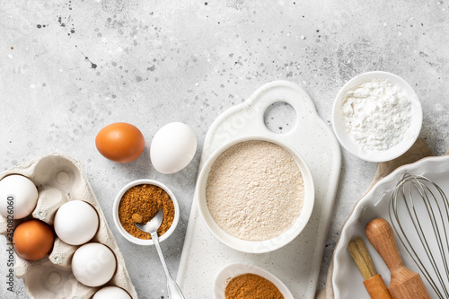 Ingredients for baking on a culinary background. Eggs, flour, cinnamon, sugar, soda on the kitchen table. Concept of preparation for baking. Top view with space for text
