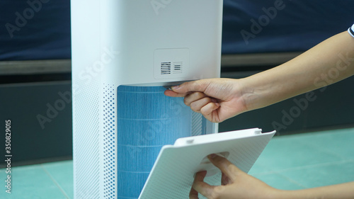replaced a new filter into the air purifier machine. Preventing allergies. PM 2.5, Dirty air filter need to maintenance.