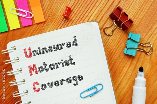 Financial concept about Uninsured Motorist Coverage UM Definition with inscription on the piece of paper.