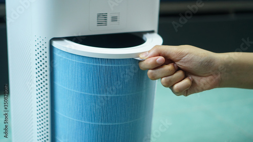 replaced a new filter into the air purifier machine. Preventing allergies. PM 2.5, Dirty air filter need to maintenance.