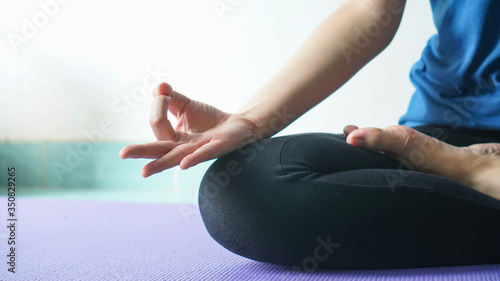 woman in meditating yoga instructor. sitting on lotus pose at home. Yoga concept.healthy lifestyle concept.