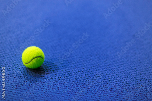 Tennis ball on blue indoor carpet © DVS