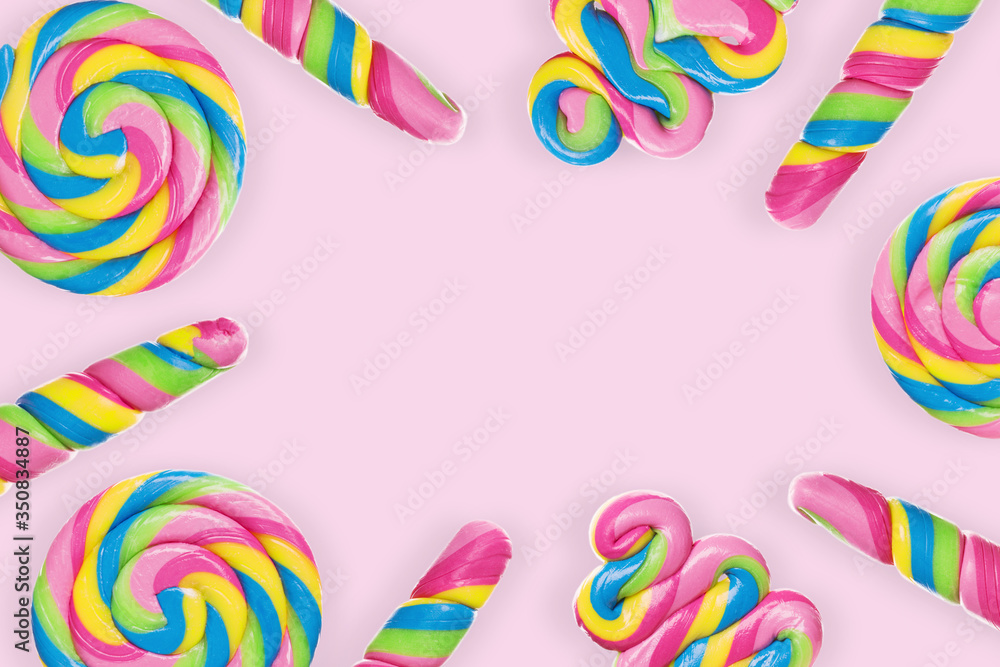 Obraz premium A lot of colorful lollipops , frame with pink background