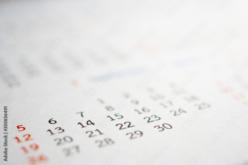 Close up calendar page dates abstract blurred background business planning appointment meeting concept Close up calendar page dates abstract blurred background business planning appointment meeting concept