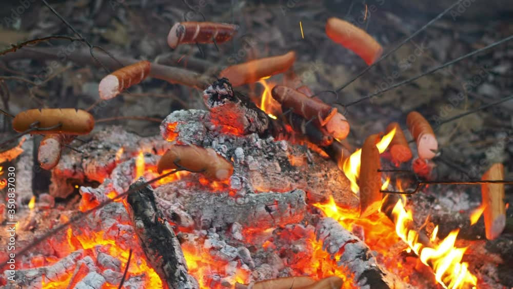 Sausages grilling on the Bonfire in 4k Slow motion 60fps Sausages grilling on the Bonfire in 4k Slow motion 60fps