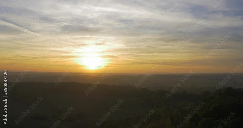 Fast aerial shot with glorious sunset and dusk-lit landscape Fast aerial shot with glorious sunset and dusk-lit landscape