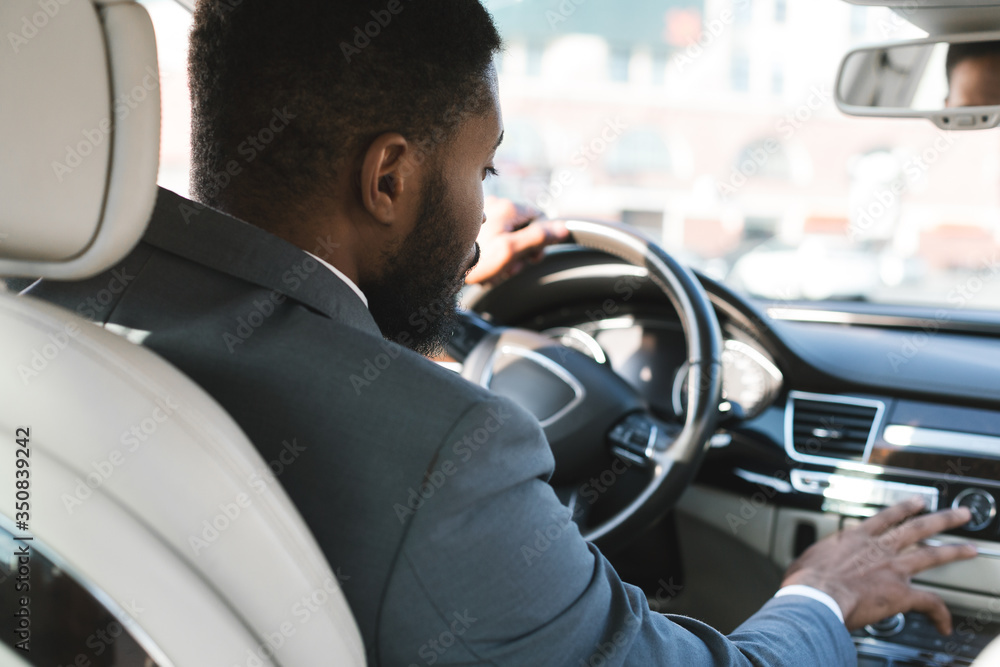 Unrecognizable Businessman Driving And Pushing Buttons Testing Car, Back View Unrecognizable Businessman Driving And Pushing Buttons Testing Car, Back View