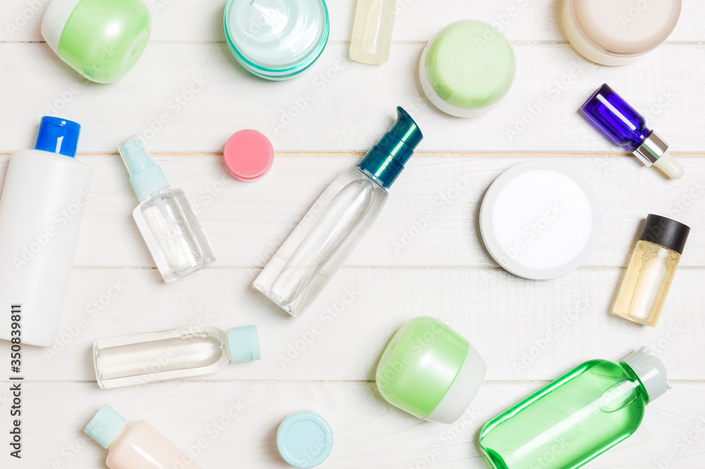 Group of plastic bodycare bottle Flat lay composition with cosmetic products on wooden background empty space for you design. Set of White Cosmetic containers, top view with copy space Group of plastic bodycare bottle Flat lay composition with cosmetic products on wooden background empty space for you design. Set of White Cosmetic containers, top view with copy space