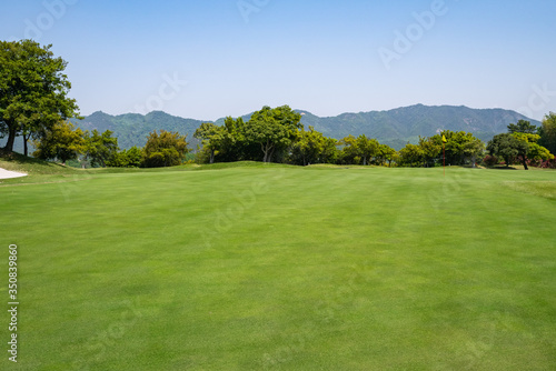 View of Golf Course with beautiful putting green. Golf course with a rich green turf beautiful scenery.