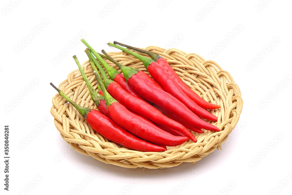 Red hot chili peppers in basktery isolated on white background. Selective focus