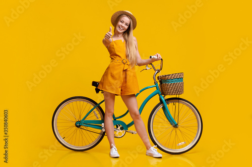 Eco Transport. Girl Standing Next To Vintage Bike And Showing Thumb Up © Prostock-studio
