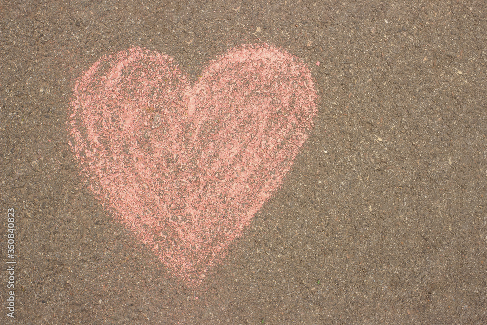 heart is drawn in red chalk on the asphalt heart is drawn in red chalk on the asphalt