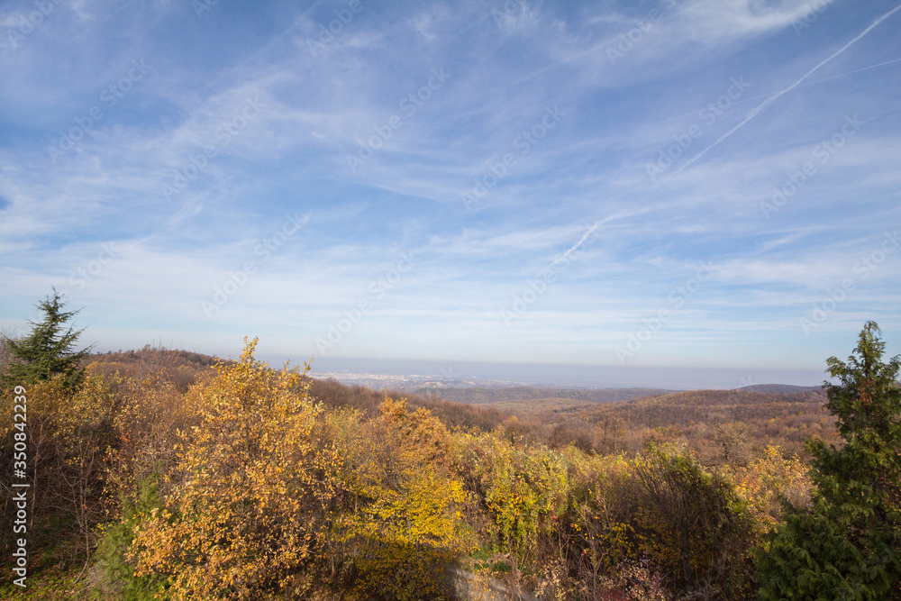 Panorama of Fruska gora mountains, from a top of a hill, with mounts covered with trees wih yellow leaves, typical from Autumn. Fruska Gora is a national park of wood and forest in Vojvodina, Serbia