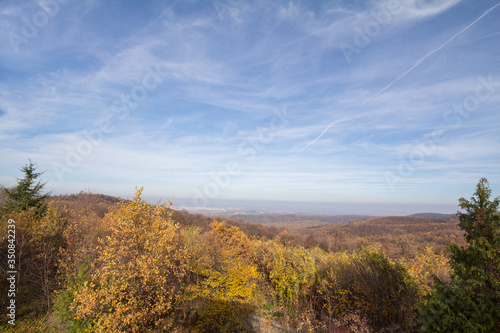Panorama of Fruska gora mountains, from a top of a hill, with mounts covered with trees wih yellow leaves, typical from Autumn. Fruska Gora is a national park of wood and forest in Vojvodina, Serbia