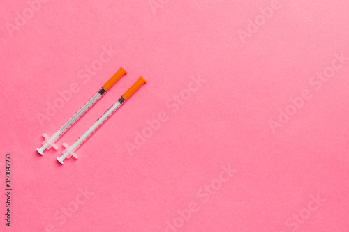 Top view of insulin syringes ready for injection on colorful background. Diabetic concept with copy space