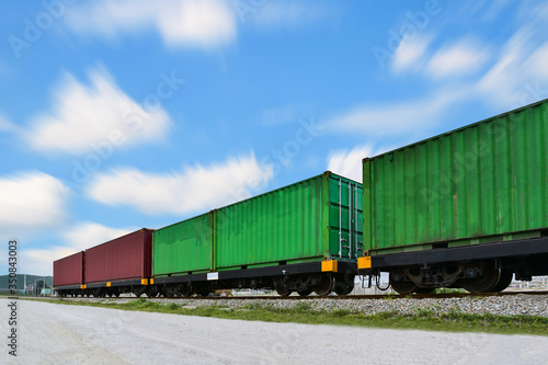 Freight Train with old Cargo Containers box, Transport, Shipping import Export on blue sky background
